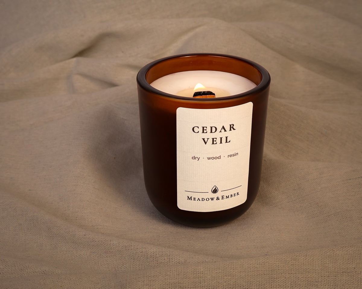 Lit Cedar Veil candle by Meadow & Ember.